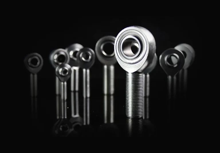 Multiple heim joints displayed in various sizes on a reflective black surface