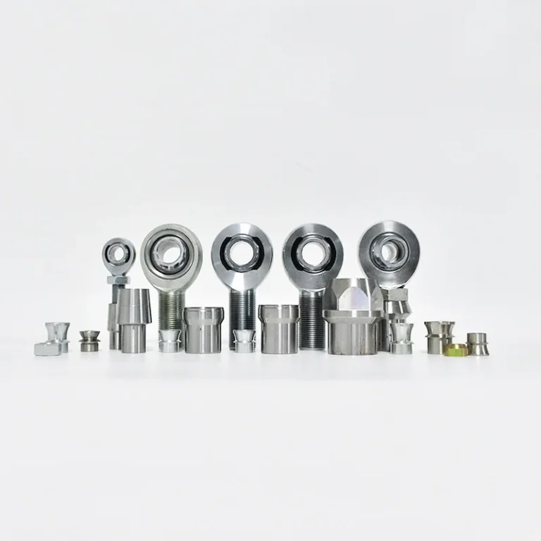 heimjointaccessoriestubeadaptersjamnutsspacers SYZ Rod Ends A collection of heim joints with accessories including tube adapters, jam nuts, spacers, and related components, arranged in a row.