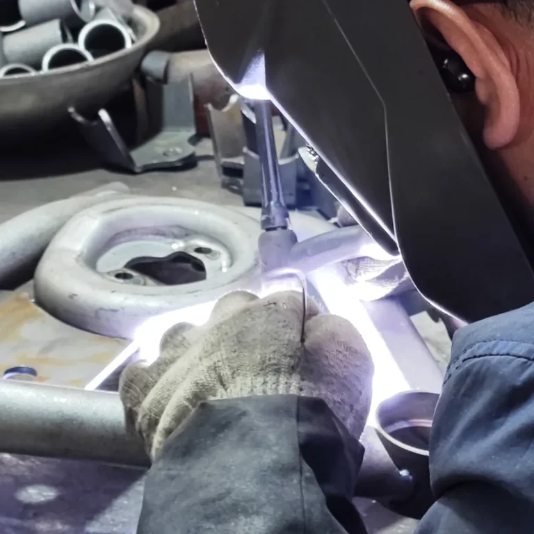 a worker welding SYZ Rod Ends